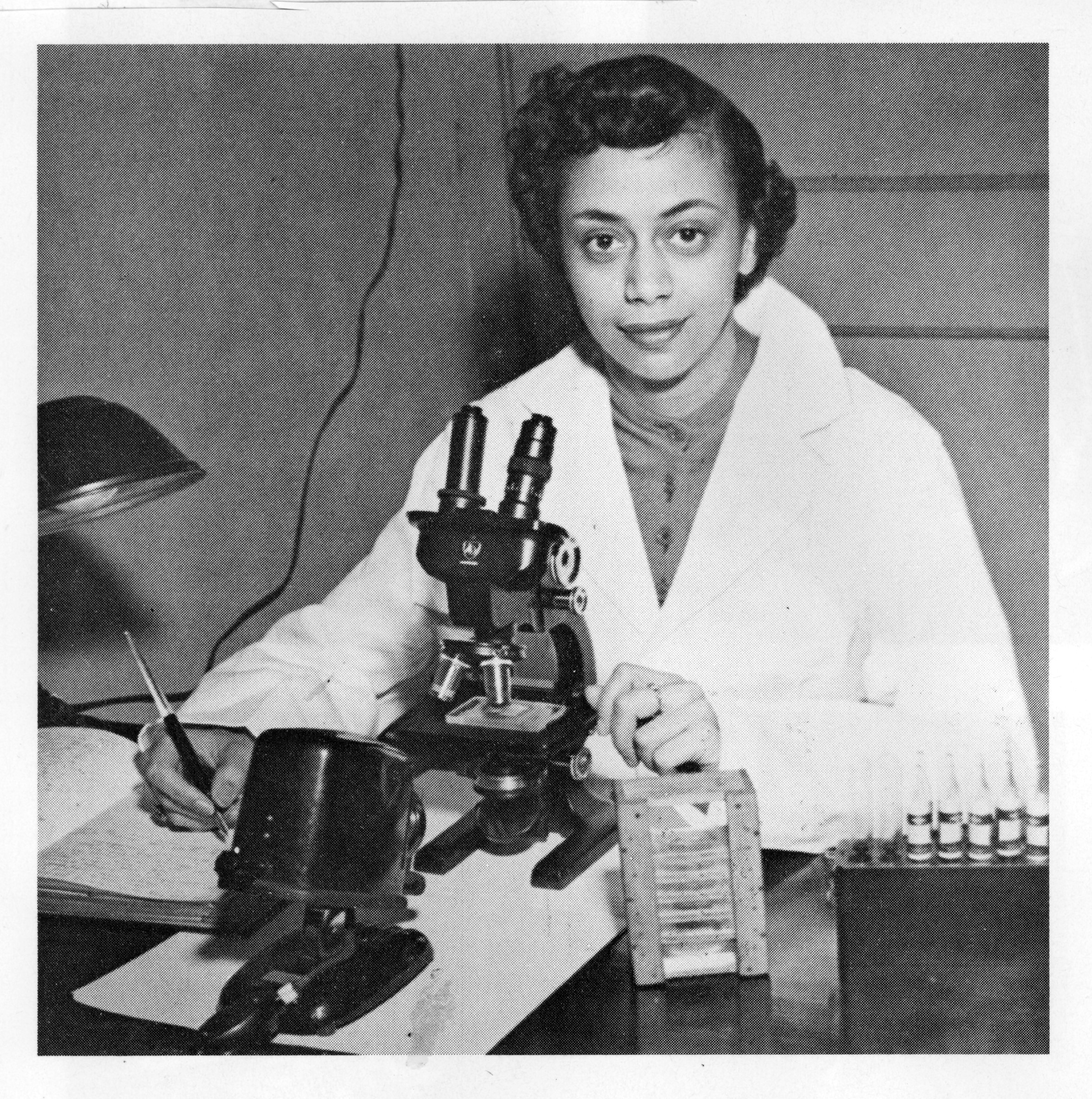 A photo of Jewell Plummer Cobb using a microscope.