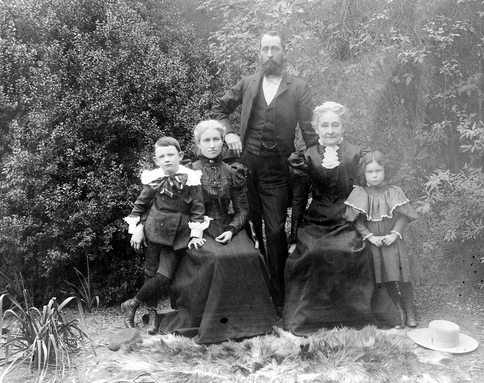 Edwardian era photo of  the Otto Des Granges Family on their ranch in Fullerton. Otto is standing with his wife Jennie and  mother seated on either side, holding Otto's children Helen and Paul.